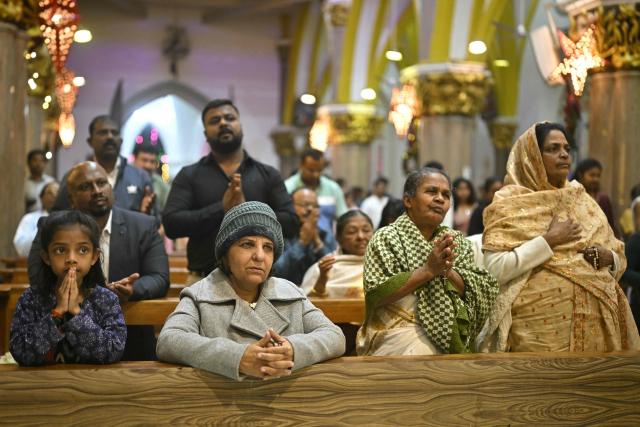 Christian devotees offer prayers on the eve of Christmas at St. Mary’s Basilica in Bengaluru on December 24, 2025. (Photo by Idrees MOHAMMED / AFP)
