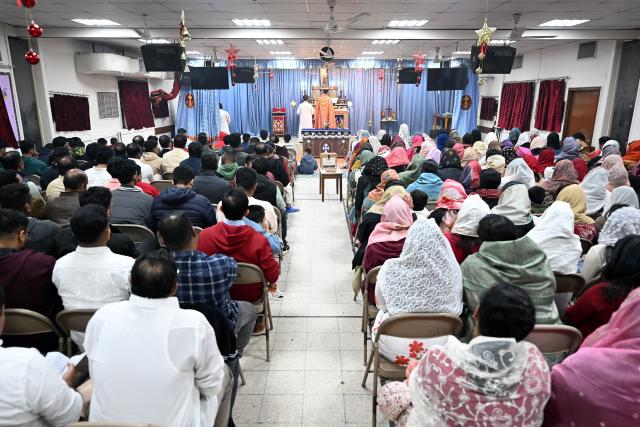 Christian worshippers attend a Christmas mass at the National Evangelical Church in Kuwait City on December 24, 2025. (Photo by YASSER AL-ZAYYAT / AFP)
