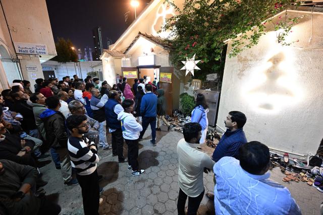 Christian worshippers arrive to attend a Christmas mass at the National Evangelical Church in Kuwait City on December 24, 2025 (Photo by YASSER AL-ZAYYAT / AFP)