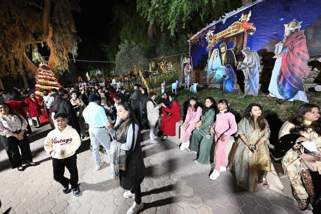 Christian worshippers arrive to attend a Christmas mass at the National Evangelical Church in Kuwait City on December 24, 2025 (Photo by YASSER AL-ZAYYAT / AFP)