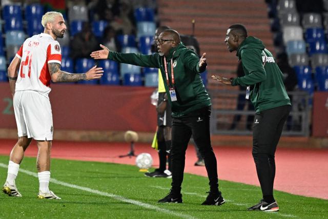 Mozambique's midfielder #21 Ricardo Guimaraes (L) speaks to Mozambique's head coach Chiquinho Conde (C) during the Africa Cup of Nations (CAN) Group F football match between Ivory Coast and Mozambique at Marrakesh Stadium in Marrakesh on December 24, 2025. (Photo by Khaled DESOUKI / AFP)
