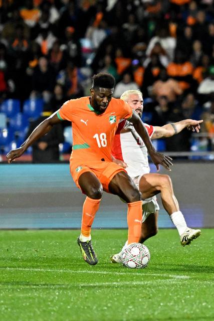Ivory Coast's midfielder #18 Ibrahim Sangare and Mozambique's midfielder #21 Ricardo Guimaraes compete for the ball during the Africa Cup of Nations (CAN) Group F football match between Ivory Coast and Mozambique at Marrakesh Stadium in Marrakesh on December 24, 2025. (Photo by Khaled DESOUKI / AFP)