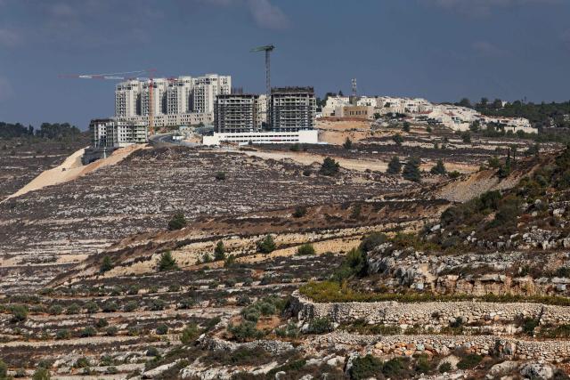 (FILES) Newly constructed buildings are pictured in the Israeli settlement of Givat Zeev near the Palestinian city of Ramallah in the occupied West Bank on October 24, 2025. Fourteen countries, including France, Britain, Canada and Japan, condemned on December 24, 2025, Israel's recent approval of new Jewish settlements in the occupied West Bank. (Photo by Ahmad GHARABLI / AFP)