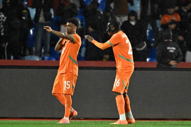 Ivory Coast's forward #15 Amad Diallo (L) celebrates scoring the team's first goal with Ivory Coast's forward #26 Yan Diomande during the Africa Cup of Nations (CAN) Group F football match between Ivory Coast and Mozambique at Marrakesh Stadium in Marrakesh on December 24, 2025. (Photo by Khaled DESOUKI / AFP)