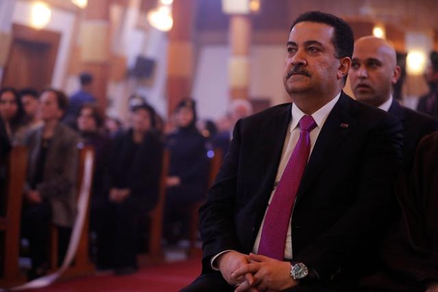 Iraqi Prime Minister Mohammed Shia al-Sudani attends with Christians in celebrating the birth of Jesus Christ during the Christmas Eve Mass at Our Lady of Salvation Church in Baghdad on December 24, 2025. (Photo by AHMAD AL-RUBAYE / AFP)