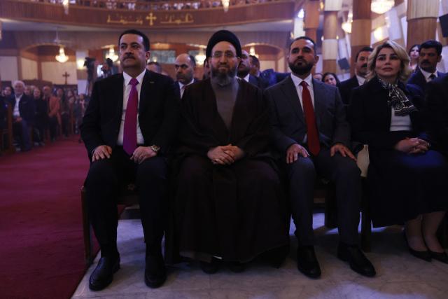 Iraqi Prime Minister Mohammed Shia al-Sudani (L) Shiite Muslim cleric Ammar al-Hakim (2nd L) attends with Christians in celebrating the birth of Jesus Christ during the Christmas Eve Mass at Our Lady of Salvation Church in Baghdad on December 24, 2025. (Photo by AHMAD AL-RUBAYE / AFP)