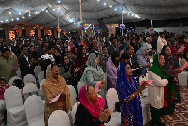Christian devotees attend a midnight Christmas mass on Christmas Eve at the Central Brooks Memorial Church in Karachi on December 24, 2025. (Photo by Rizwan TABASSUM / AFP)