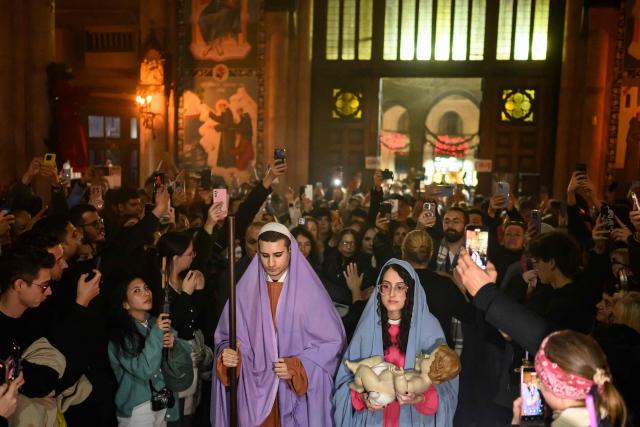 Catholic Christian devotees reenact the Nativity scene during a Christmas Eve mass at the Saint Antuan church, the largest Roman Catholic Church in Istanbul, on December 24, 2025. (Photo by Yasin AKGUL / AFP)