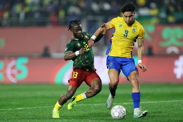 Cameroon's defender #13 Darlin Yongwa (L) challenges Gabon's defender #03 Anthony Oyono during the Africa Cup of Nations (CAN) Group F football match between Cameroon and Gabon at Adrar Stadium in Agadir on December 24, 2025. (Photo by FRANCK FIFE / AFP)