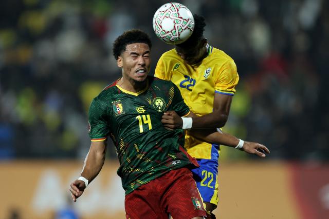 Cameroon's midfielder #14 Danny Namaso (L) and Gabon's midfielder #22 Didier Ndong jump for the ball during the Africa Cup of Nations (CAN) Group F football match between Cameroon and Gabon at Adrar Stadium in Agadir on December 24, 2025. (Photo by FRANCK FIFE / AFP)