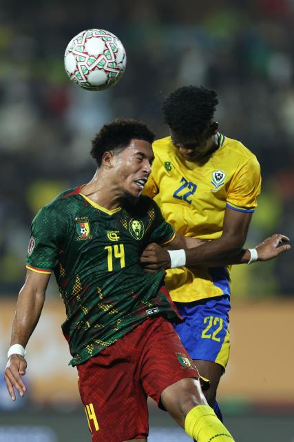 Cameroon's midfielder #14 Danny Namaso (L) and Gabon's midfielder #22 Didier Ndong jump for the ball during the Africa Cup of Nations (CAN) Group F football match between Cameroon and Gabon at Adrar Stadium in Agadir on December 24, 2025. (Photo by FRANCK FIFE / AFP)