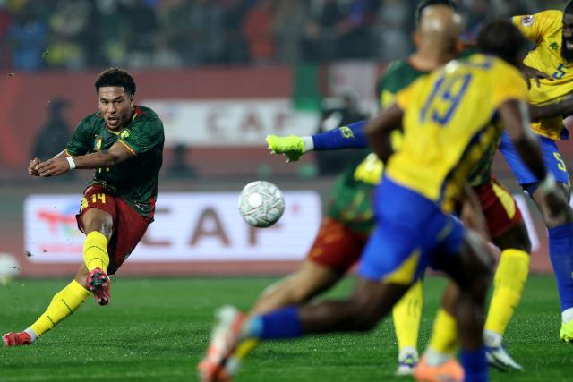 Cameroon's midfielder #14 Danny Namaso (L) shoots but fails to score during the Africa Cup of Nations (CAN) Group F football match between Cameroon and Gabon at Adrar Stadium in Agadir on December 24, 2025. (Photo by FRANCK FIFE / AFP)