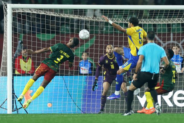 Cameroon's Che Malone (L) heads the ball during the Africa Cup of Nations (CAN) Group F football match between Cameroon and Gabon at Adrar Stadium in Agadir on December 24, 2025. (Photo by FRANCK FIFE / AFP)