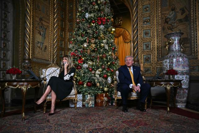 US President Donald Trump and first lady Melania Trump participate in NORAD Santa tracker phone calls, on Christmas Eve, from the Mar-a-lago club in Palm Beach, Florida, on December 24, 2025. (Photo by ANDREW CABALLERO-REYNOLDS / AFP)