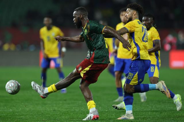 Cameroon's midfielder #08 Jean Onana gets the ball away from Gabon's forward #20 Denis Bouanga during the Africa Cup of Nations (CAN) Group F football match between Cameroon and Gabon at Adrar Stadium in Agadir on December 24, 2025. (Photo by FRANCK FIFE / AFP)