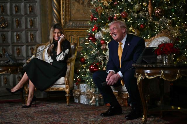 US President Donald Trump and first lady Melania Trump participate in NORAD Santa tracker phone calls, on Christmas Eve, from the Mar-a-lago club in Palm Beach, Florida, on December 24, 2025. (Photo by ANDREW CABALLERO-REYNOLDS / AFP)
