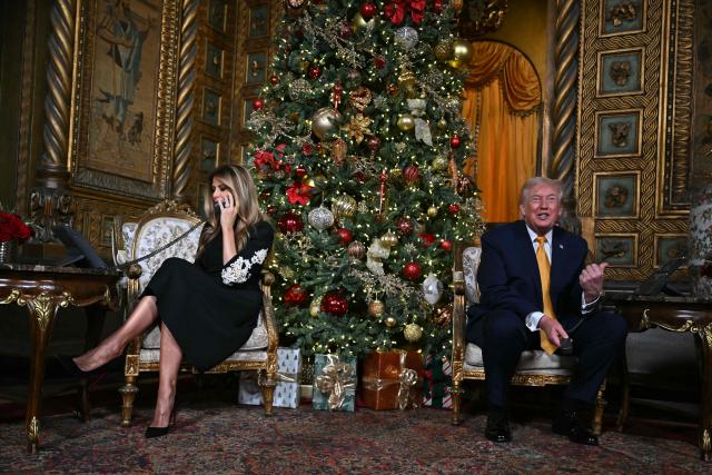 US President Donald Trump and first lady Melania Trump participate in NORAD Santa tracker phone calls, on Christmas Eve, from the Mar-a-lago club in Palm Beach, Florida, on December 24, 2025. (Photo by ANDREW CABALLERO-REYNOLDS / AFP)