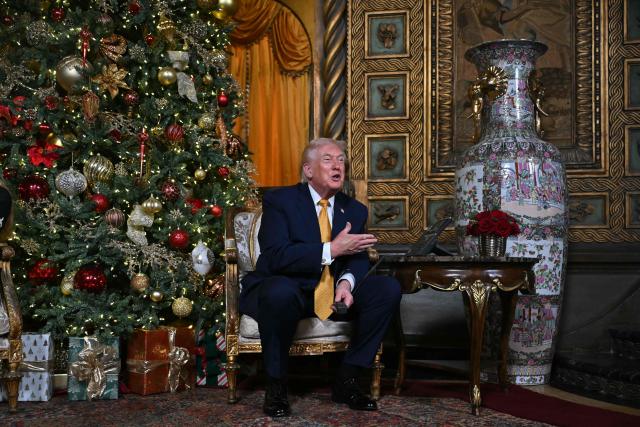 US President Donald Trump participates in NORAD Santa tracker phone calls, on Christmas Eve, from the Mar-a-lago club in Palm Beach, Florida, on December 24, 2025. (Photo by ANDREW CABALLERO-REYNOLDS / AFP)