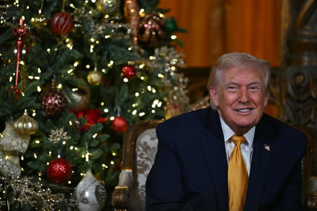 US President Donald Trump participates in NORAD Santa tracker phone calls, on Christmas Eve, from the Mar-a-lago club in Palm Beach, Florida, on December 24, 2025. (Photo by ANDREW CABALLERO-REYNOLDS / AFP)