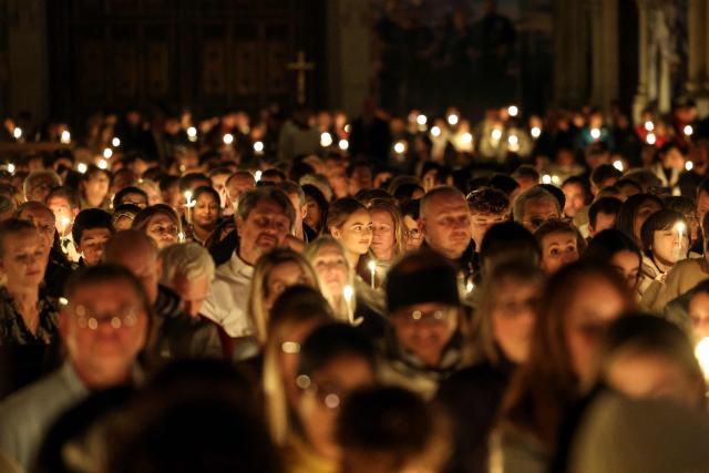 People attend a Christmas Mass at St. Patrick’s Cathedral on Christmas Eve on December 24, 2025 in New York. (Photo by ANGELA WEISS / AFP)