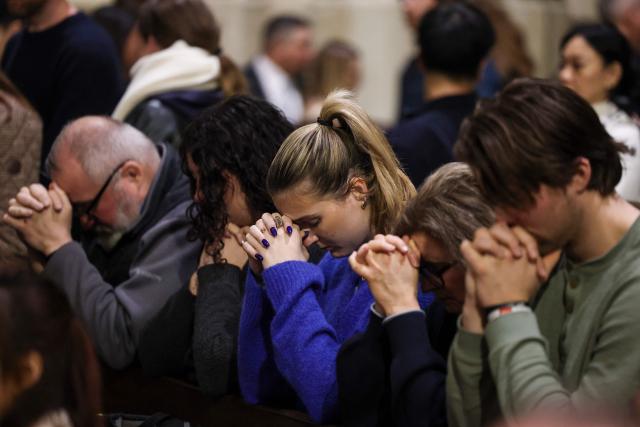 People attend a Christmas Mass at St. Patrick’s Cathedral on Christmas Eve on December 24, 2025 in New York. (Photo by ANGELA WEISS / AFP)