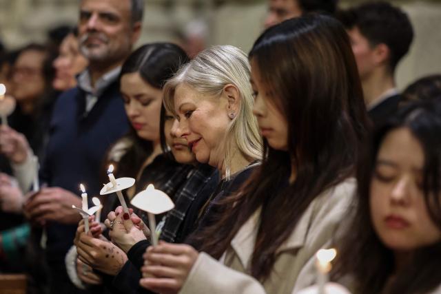 People attend a Christmas Mass at St. Patrick’s Cathedral on Christmas Eve on December 24, 2025 in New York. (Photo by ANGELA WEISS / AFP)