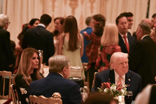 US President Donald Trump and first lady Melania Trump attend a Christmas dinner at his Mar-a-Lago resort in Palm Beach, Florida, on December 24, 2025. (Photo by ANDREW CABALLERO-REYNOLDS / AFP)