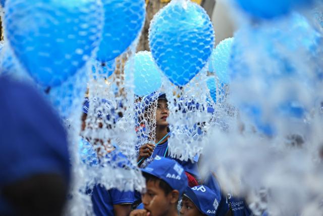 Supporters hold blue balloons as they attend an election campaign event by Thet Thet Khine, chairperson of the People's Pioneer Party (PPP), in Yangon on December 25, 2025. (Photo by Sai Aung MAIN / AFP)