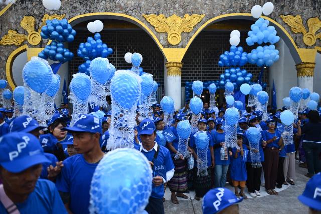Supporters hold blue balloons as they attend an election campaign event by Thet Thet Khine, chairperson of the People's Pioneer Party (PPP), in Yangon on December 25, 2025. (Photo by Sai Aung MAIN / AFP)