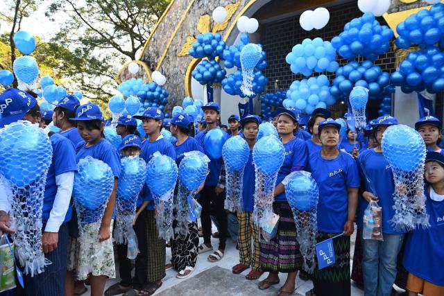 Supporters hold blue balloons as they attend an election campaign event by Thet Thet Khine, chairperson of the People's Pioneer Party (PPP), in Yangon on December 25, 2025. (Photo by Sai Aung MAIN / AFP)