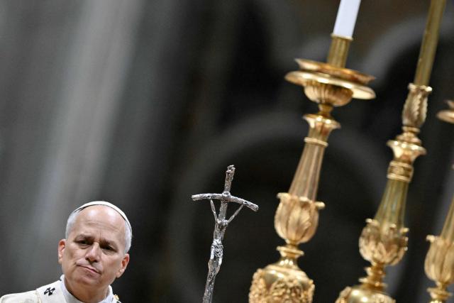 Pope Leo XIV looks on as he performs the Christmas mass at St Peter's Basilica in the Vatican on December 25, 2025. (Photo by Tiziana FABI / AFP)