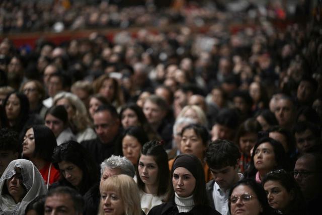 Faithfull attend Pope Leo XIV performing the Christmas mass at St Peter's Basilica in the Vatican on December 25, 2025. (Photo by Tiziana FABI / AFP)