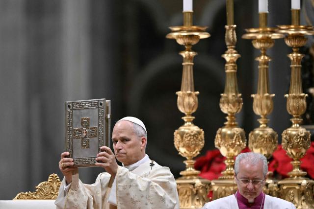 Pope Leo XIV performs the Christmas mass at St Peter's Basilica in the Vatican on December 25, 2025. (Photo by Tiziana FABI / AFP)