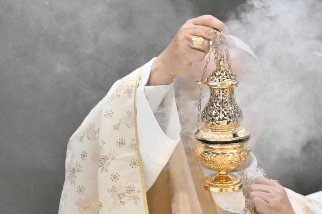 Pope Leo XIV holds an incent burner as he performs the Christmas mass at St Peter's Basilica in the Vatican on December 25, 2025. (Photo by Tiziana FABI / AFP)
