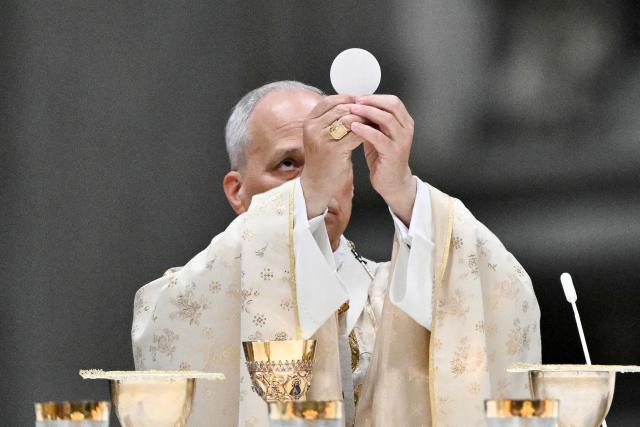 Pope Leo XIV performs the Christmas mass at St Peter's Basilica in the Vatican on December 25, 2025. (Photo by Tiziana FABI / AFP)