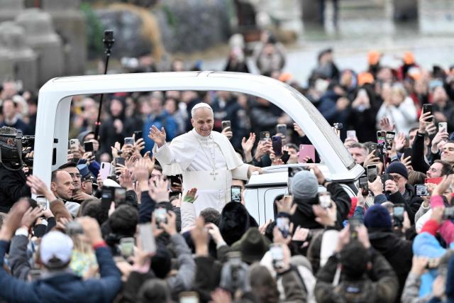 Pope Leo XIV waves to faithfull as he arrives aboard the popemobile ahead of addressing the Urbi et Orbi message and blessing to the city and the world as part of Christmas celebrations, at St Peter's square in the Vatican on December 25, 2025. (Photo by Tiziana FABI / AFP)