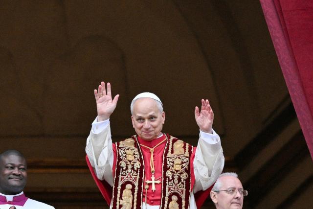 Pope Leo XIV waves to the faithfull after delivering from the main balcony of St. Peter's basilica the Urbi et Orbi message and blesses to the city and the world as part of Christmas celebrations, at St Peter's square in the Vatican on December 25, 2025. (Photo by Tiziana FABI / AFP)