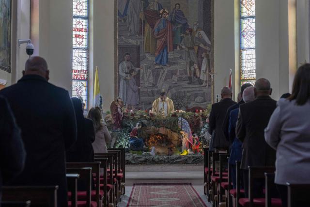 Abouna Bashar Basiel leads a Christmas morning mass at the Christ the Redeemer Church in the mostly Christian town of Taybeh, in the Israeli-occupied West Bank on December 25, 2025. (Photo by ILIA YEFIMOVICH / AFP)