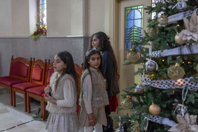 Worshippers gather during a Christmas morning mass at the Christ the Redeemer Church in the mostly Christian town of Taybeh, in the Israeli-occupied West Bank on December 25, 2025. (Photo by ILIA YEFIMOVICH / AFP)