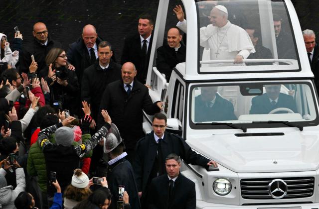 Pope Leo XIV waves to faithfull as he arrives aboard the popemobile ahead of addressing the Urbi et Orbi message and blessing to the city and the world as part of Christmas celebrations, at St Peter's square in the Vatican on December 25, 2025. (Photo by Andreas SOLARO / AFP)