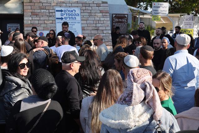 Relatives and friends of Dan Elkayam, 27, a French Jewish engineer from Le Bourget, who was killed in the terrorist attack that struck Bondi Beach in Australia on December 14, during the Jewish holiday of Hanukkah, mourn during his funeral at the Ashdod cemetery in southern Israel on December 25, 2025. Fresh details about the run-up to the Bondi killings have emerged in recent days. Police documents released December 22, said the two alleged gunmen had carried out "firearms training" in what was believed to be the New South Wales countryside. Authorities alleged the pair "meticulously planned" the attack "for many months". (Photo by Jack GUEZ / AFP)