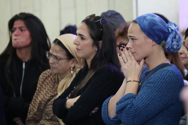 Relatives and friends of Dan Elkayam, 27, a French Jewish engineer from Le Bourget, who was killed in the terrorist attack that struck Bondi Beach in Australia on December 14, during the Jewish holiday of Hanukkah, mourn during his funeral at the Ashdod cemetery in southern Israel on December 25, 2025. Fresh details about the run-up to the Bondi killings have emerged in recent days. Police documents released December 22, said the two alleged gunmen had carried out "firearms training" in what was believed to be the New South Wales countryside. Authorities alleged the pair "meticulously planned" the attack "for many months". (Photo by Jack GUEZ / AFP)