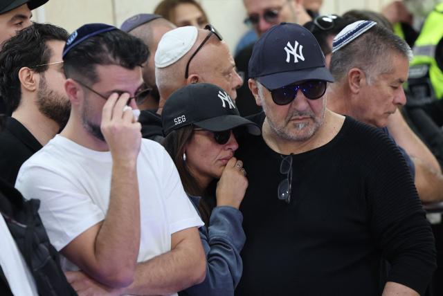 Relatives and friends of Dan Elkayam, 27, a French Jewish engineer from Le Bourget, who was killed in the terrorist attack that struck Bondi Beach in Australia on December 14, during the Jewish holiday of Hanukkah, mourn during his funeral at the Ashdod cemetery in southern Israel on December 25, 2025. Fresh details about the run-up to the Bondi killings have emerged in recent days. Police documents released December 22, said the two alleged gunmen had carried out "firearms training" in what was believed to be the New South Wales countryside. Authorities alleged the pair "meticulously planned" the attack "for many months". (Photo by Jack GUEZ / AFP)