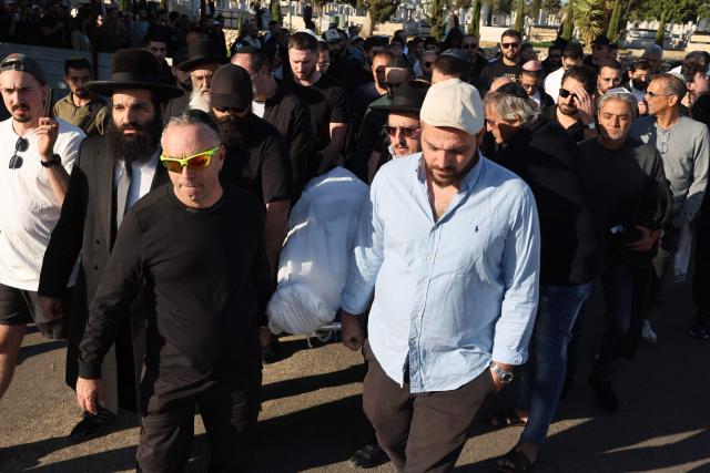 Relatives and friends of Dan Elkayam, 27, a French Jewish engineer from Le Bourget, who was killed in the terrorist attack that struck Bondi Beach in Australia on December 14, during the Jewish holiday of Hanukkah, carry his body during his funeral at the Ashdod cemetery in southern Israel on December 25, 2025. Fresh details about the run-up to the Bondi killings have emerged in recent days. Police documents released December 22, said the two alleged gunmen had carried out "firearms training" in what was believed to be the New South Wales countryside. Authorities alleged the pair "meticulously planned" the attack "for many months". (Photo by Jack GUEZ / AFP)