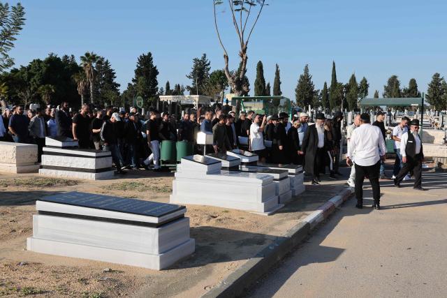 Relatives and friends of Dan Elkayam, 27, a French Jewish engineer from Le Bourget, who was killed in the terrorist attack that struck Bondi Beach in Australia on December 14, during the Jewish holiday of Hanukkah, mourn his coffin during his funeral at the Ashdod cemetery in southern Israel on December 25, 2025. Fresh details about the run-up to the Bondi killings have emerged in recent days. Police documents released December 22, said the two alleged gunmen had carried out "firearms training" in what was believed to be the New South Wales countryside. Authorities alleged the pair "meticulously planned" the attack "for many months". (Photo by Jack GUEZ / AFP)