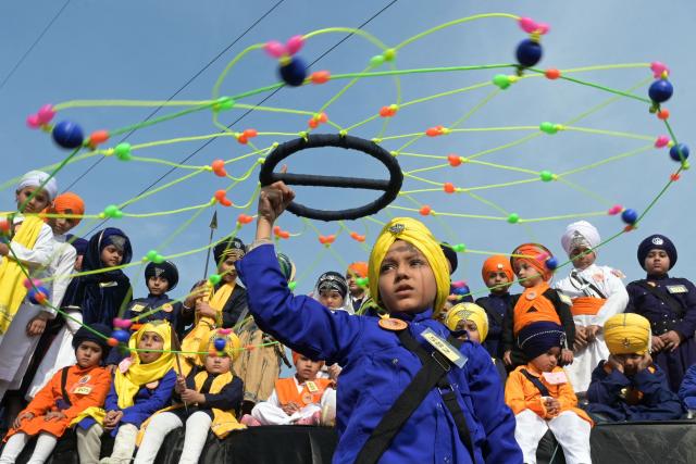 A Sikh youth performs 'Gatka', a martial art form, during an event commemorating the martyrdom of the sons of Sikh Guru Gobind Singh in Amritsar on December 25, 2025. (Photo by Narinder NANU / AFP)