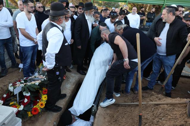 Relatives and friends of Dan Elkayam, 27, a French Jewish engineer from Le Bourget, who was killed in the terrorist attack that struck Bondi Beach in Australia on December 14, during the Jewish holiday of Hanukkah, mourn during his funeral at the Ashdod cemetery in southern Israel on December 25, 2025. Fresh details about the run-up to the Bondi killings have emerged in recent days. Police documents released December 22, said the two alleged gunmen had carried out "firearms training" in what was believed to be the New South Wales countryside. Authorities alleged the pair "meticulously planned" the attack "for many months". (Photo by Jack GUEZ / AFP)