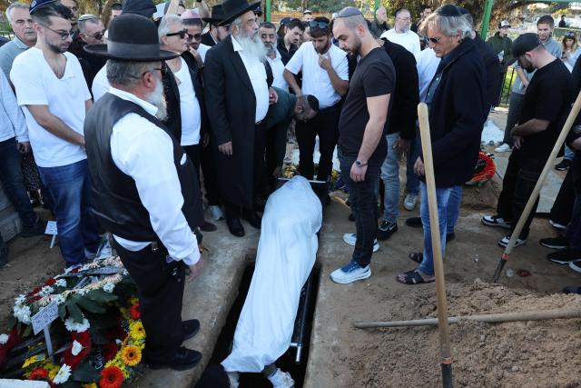 Relatives and friends of Dan Elkayam, 27, a French Jewish engineer from Le Bourget, who was killed in the terrorist attack that struck Bondi Beach in Australia on December 14, during the Jewish holiday of Hanukkah, mourn during his funeral at the Ashdod cemetery in southern Israel on December 25, 2025. Fresh details about the run-up to the Bondi killings have emerged in recent days. Police documents released December 22, said the two alleged gunmen had carried out "firearms training" in what was believed to be the New South Wales countryside. Authorities alleged the pair "meticulously planned" the attack "for many months". (Photo by Jack GUEZ / AFP)