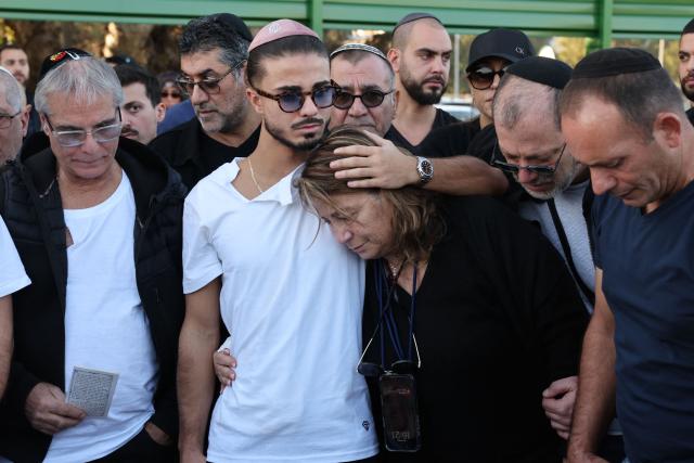 Relatives and friends of Dan Elkayam, 27, a French Jewish engineer from Le Bourget, who was killed in the terrorist attack that struck Bondi Beach in Australia on December 14, during the Jewish holiday of Hanukkah, mourn during his funeral at the Ashdod cemetery in southern Israel on December 25, 2025. Fresh details about the run-up to the Bondi killings have emerged in recent days. Police documents released December 22, said the two alleged gunmen had carried out "firearms training" in what was believed to be the New South Wales countryside. Authorities alleged the pair "meticulously planned" the attack "for many months". (Photo by Jack GUEZ / AFP)