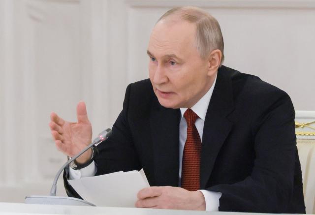In this pool photograph distributed by the Russian state agency Sputnik, Russia's President Vladimir Putin chairs a State Council meeting at the Kremlin in Moscow on December 25, 2025. (Photo by Mikhail METZEL / POOL / AFP)